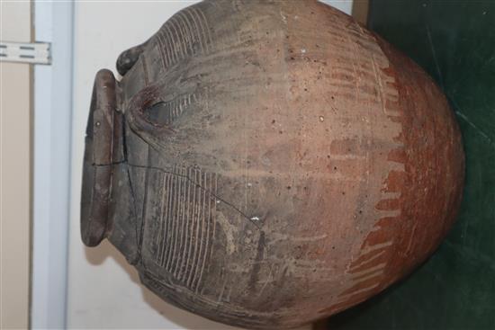 An Egyptian terracotta jar, with four carrying lug handles, Pre-Dynastic, H. 35cm, badly cracked